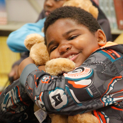 Boy hugging bear Boy hugging bear