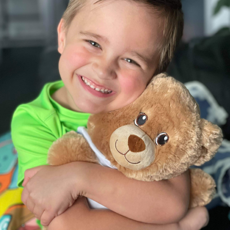 Build-A-Bear boy hugging bear