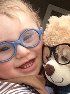 Child And Stuffed Bear Both Wearing Glasses