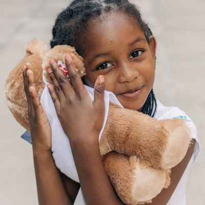 girl holding bear