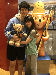 Couple Holding Stuffed Bear Together