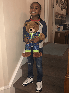 Child With Stuffed Bear in Pajamas