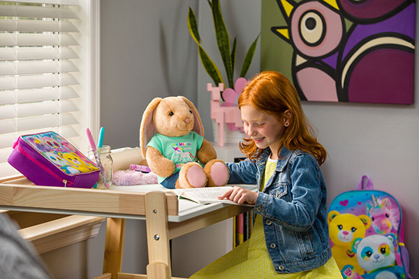 child reading with plush bunny – Build-A-Bear Foundation