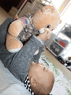 Infant With Stuffed Bear in Military Uniform